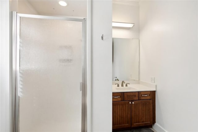 bathroom featuring vanity, crown molding, and walk in shower