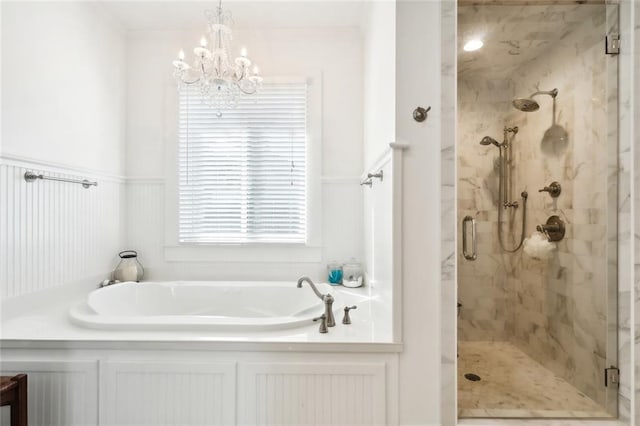 bathroom featuring an inviting chandelier and separate shower and tub