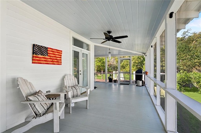 sunroom / solarium with ceiling fan and wood ceiling