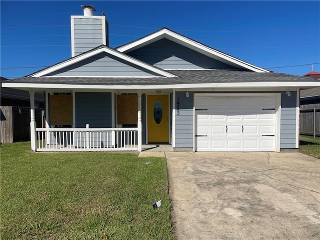 view of front of property with a porch, a front yard, and a garage