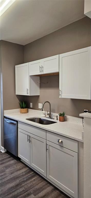 kitchen with white cabinetry, dishwasher, sink, and dark hardwood / wood-style floors