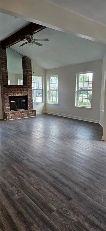 unfurnished living room featuring dark wood-type flooring, vaulted ceiling with beams, and plenty of natural light