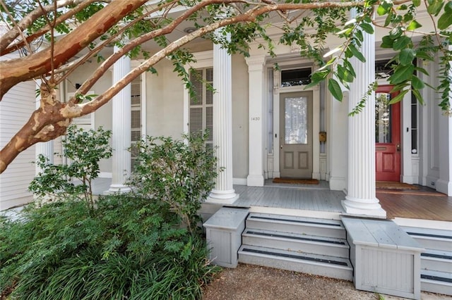 view of exterior entry featuring covered porch