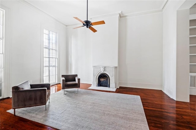 living room featuring ornamental molding, ceiling fan, and dark hardwood / wood-style flooring