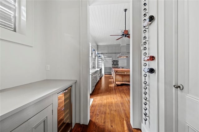 hallway featuring wine cooler and dark wood-type flooring