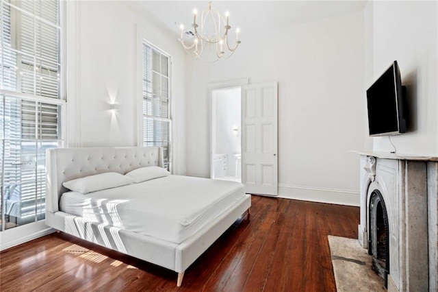 bedroom with dark wood-type flooring and a chandelier