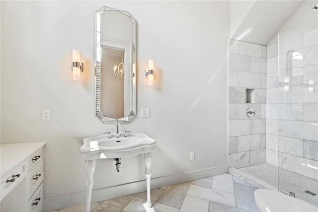 bathroom with tiled shower and toilet