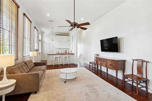 living room with ceiling fan and hardwood / wood-style flooring