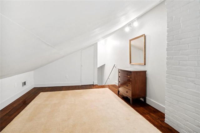 bonus room with vaulted ceiling and dark hardwood / wood-style floors