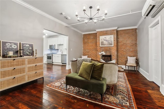 living room featuring dark wood-type flooring, a wall mounted air conditioner, brick wall, crown molding, and a brick fireplace