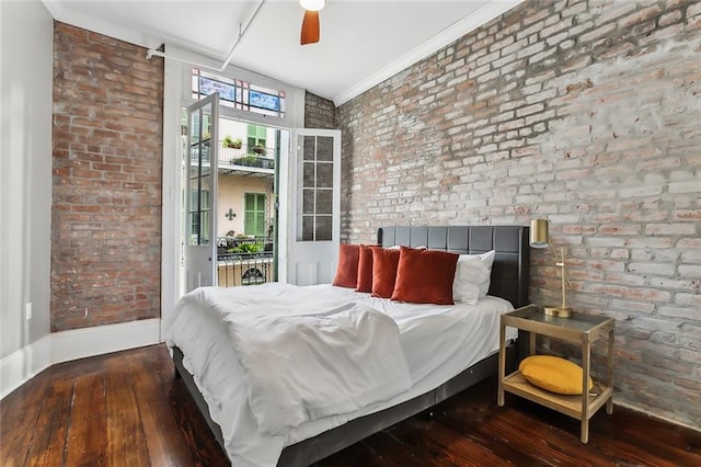 bedroom featuring ceiling fan, brick wall, wood-type flooring, and ornamental molding