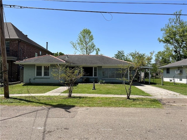 view of front of house featuring a front lawn and a carport