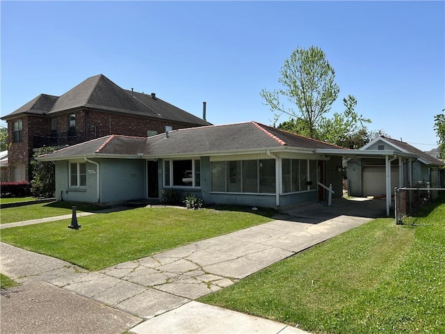 view of front facade with a sunroom, a garage, and a front yard