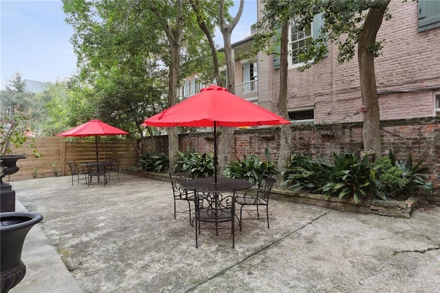 view of patio / terrace featuring fence and outdoor dining space