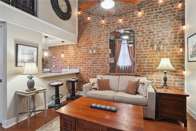 living room with brick wall and light hardwood / wood-style floors