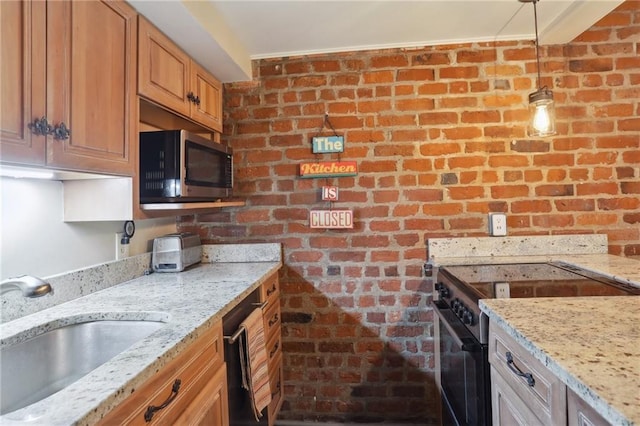 kitchen featuring a sink, brick wall, black appliances, and light stone countertops
