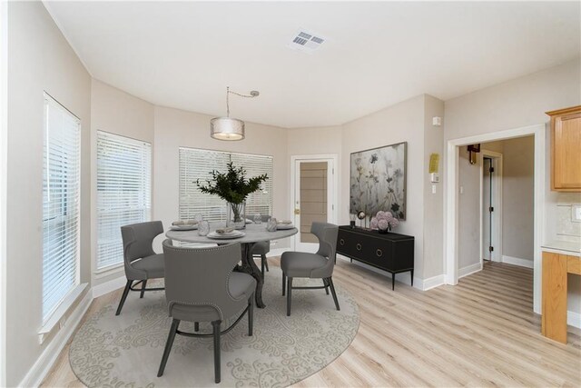 605 Florida St, Mandeville, LA 70448 - dining space with light wood-type flooring and baseboards