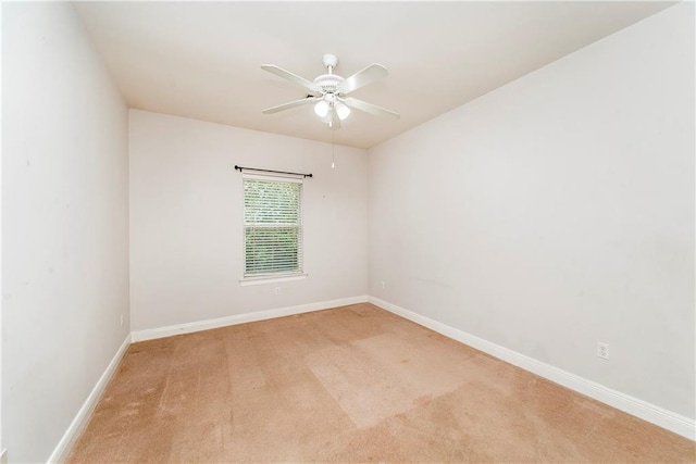 empty room featuring light carpet and ceiling fan