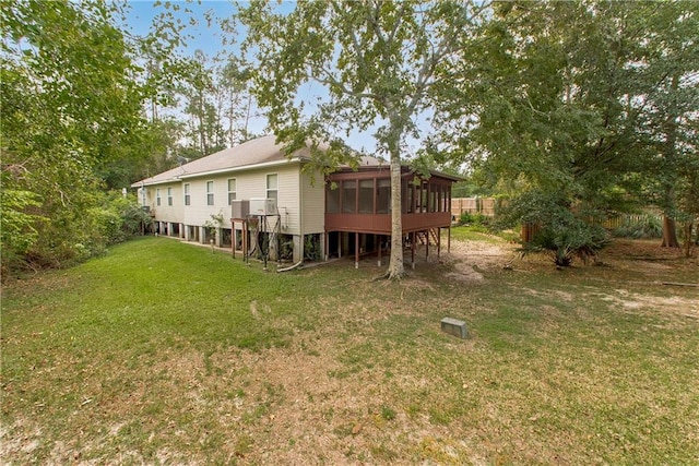 back of property featuring a yard and a sunroom