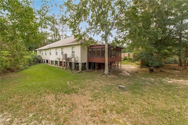 605 Florida St, Mandeville, LA 70448 - rear view of property with a sunroom and a yard
