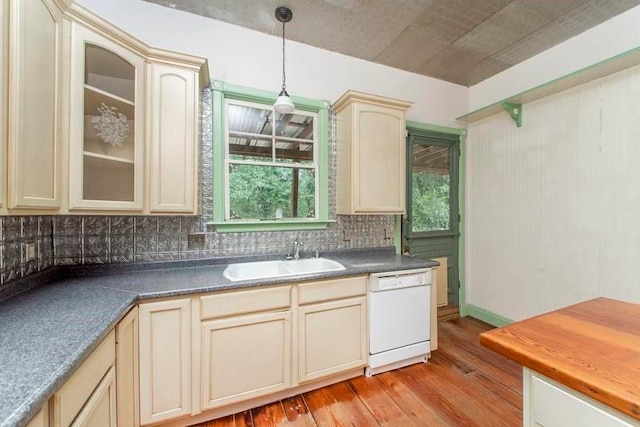 kitchen with dishwasher, decorative backsplash, cream cabinetry, sink, and light wood-type flooring