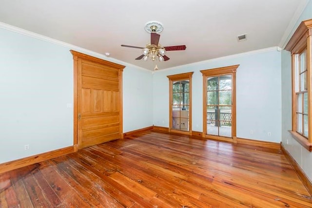 empty room with ceiling fan, crown molding, and hardwood / wood-style floors