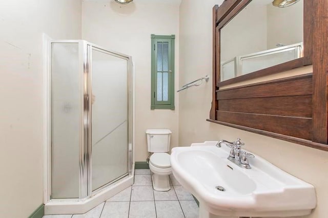 bathroom with sink, toilet, tile patterned floors, and a shower with shower door