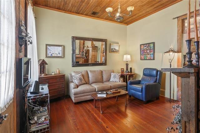 living room featuring ornamental molding, dark wood-type flooring, wood ceiling, and a notable chandelier