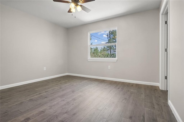 empty room featuring dark hardwood / wood-style floors and ceiling fan