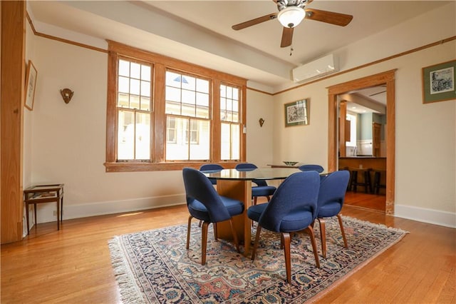 dining space with light hardwood / wood-style flooring, a wall mounted AC, and ceiling fan