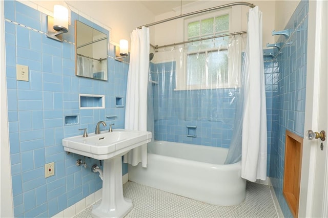 bathroom with shower / tub combo with curtain, tile patterned floors, and tile walls