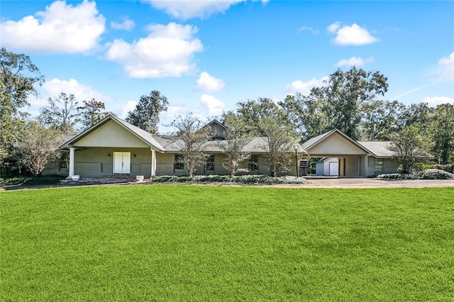 single story home featuring a front lawn and a garage