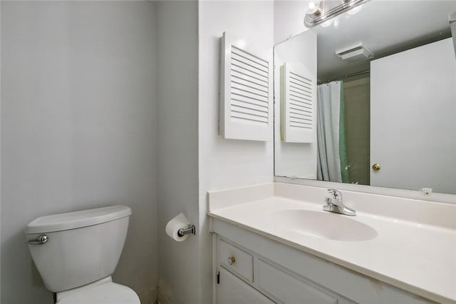 bathroom with toilet and vanity