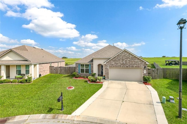 view of front of property with a front yard and a garage