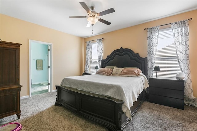 carpeted bedroom featuring ensuite bath and ceiling fan