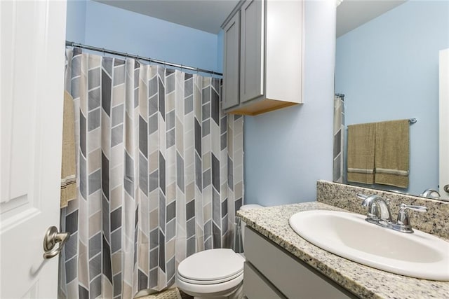 bathroom with vanity, a shower with shower curtain, and toilet