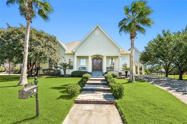 view of front of home featuring a front yard and stucco siding