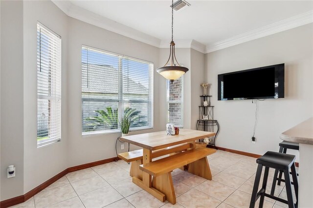 dining room featuring light tile patterned floors, visible vents, baseboards, and ornamental molding