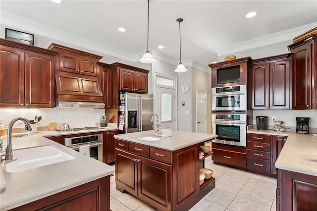 kitchen featuring an island with sink, stainless steel appliances, ornamental molding, decorative light fixtures, and light tile patterned floors