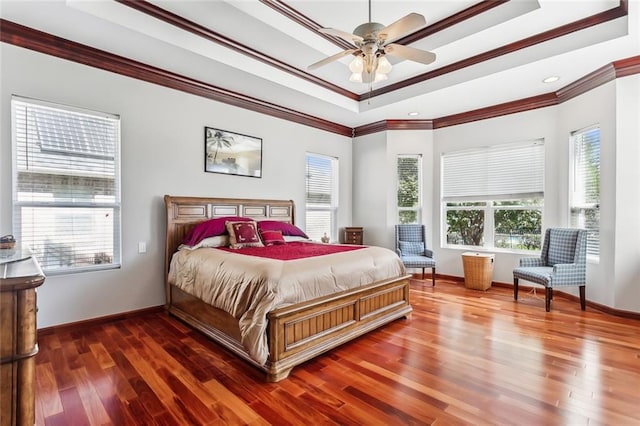 bedroom with dark wood-type flooring, multiple windows, and ceiling fan