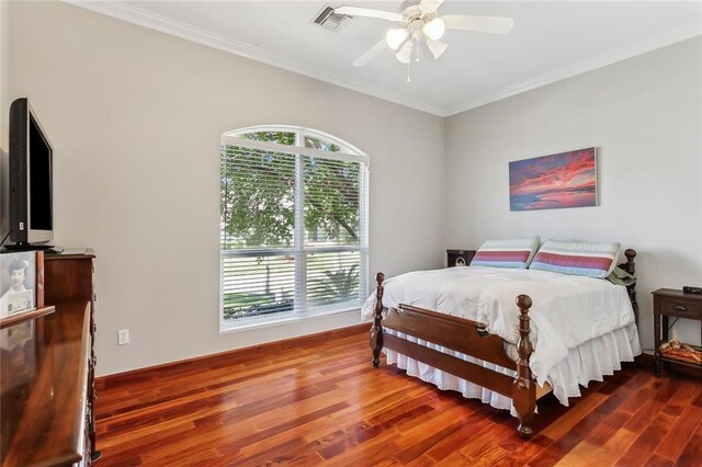 bedroom featuring visible vents, crown molding, a ceiling fan, and wood finished floors