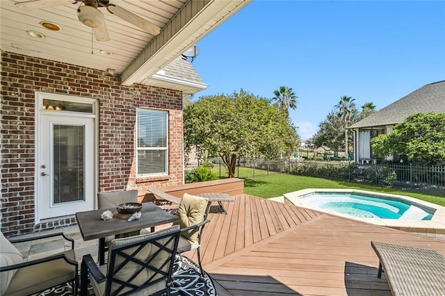 exterior space with a hot tub, a deck, and ceiling fan