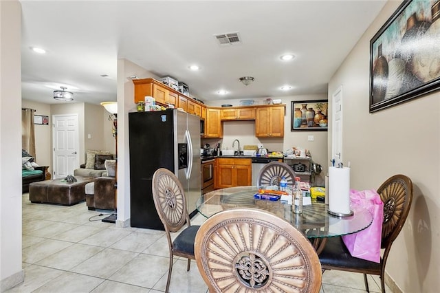 dining room with light tile patterned floors and sink