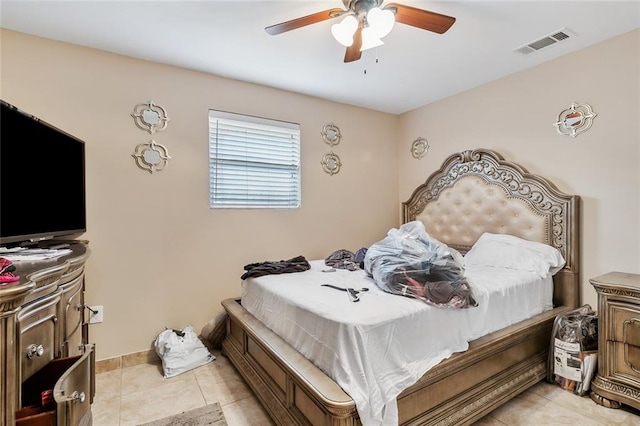 bedroom with ceiling fan and light tile patterned floors