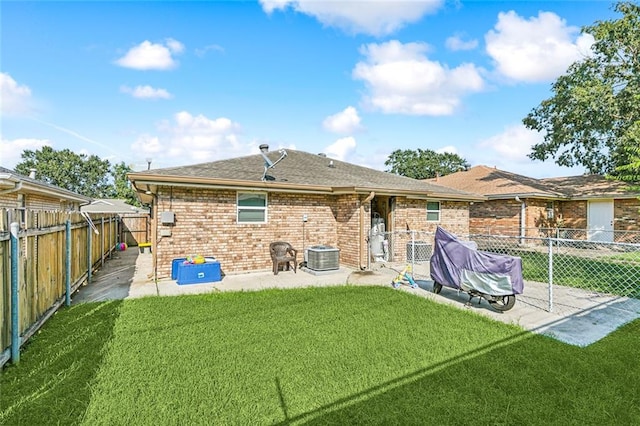 back of house with a patio area and a lawn