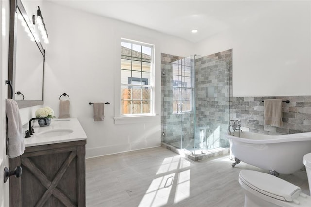 full bathroom featuring vanity, independent shower and bath, wood-type flooring, and toilet