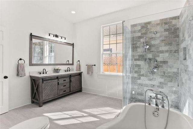 full bathroom with vanity, hardwood / wood-style flooring, toilet, and separate shower and tub