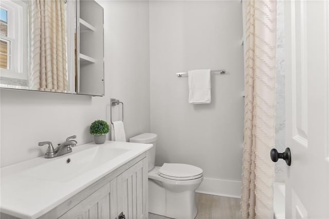 full bathroom featuring shower / tub combo with curtain, vanity, wood-type flooring, and toilet