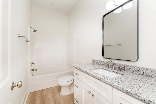 full bathroom with wood-type flooring, vanity, toilet, and bathtub / shower combination