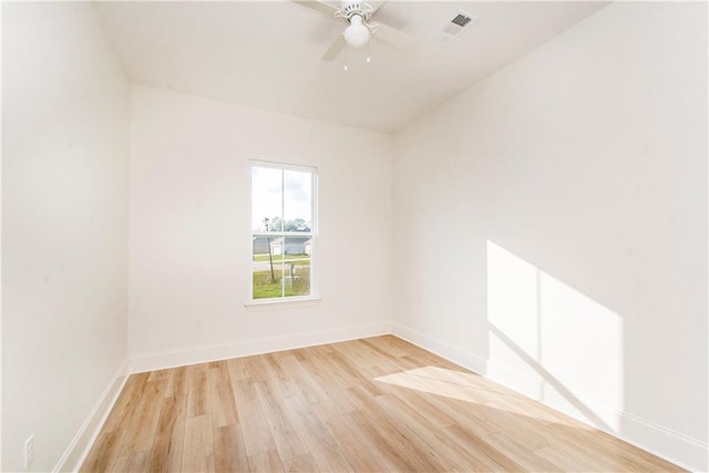 empty room featuring ceiling fan and light hardwood / wood-style flooring